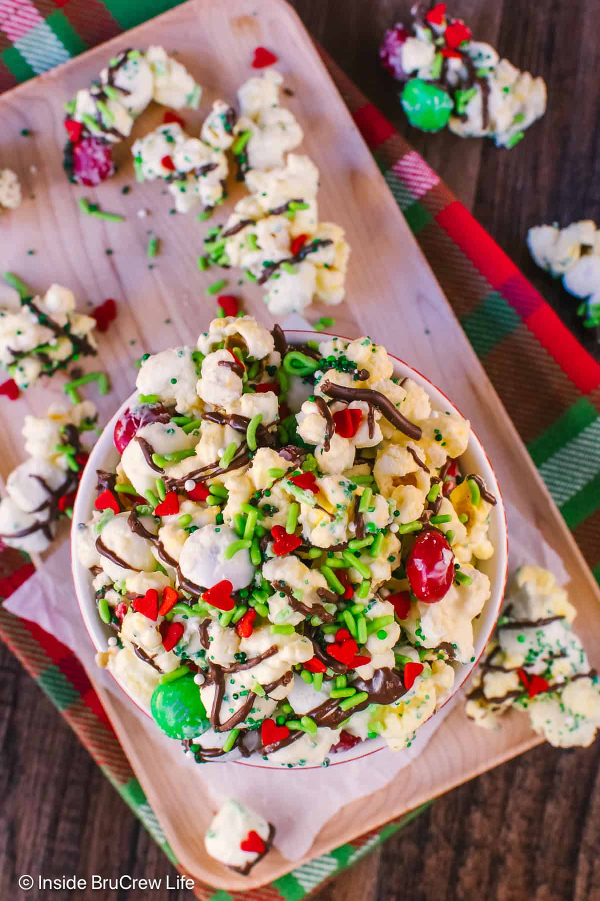 An overhead picture of a bowl of Grinch popcorn with sprinkles on it.