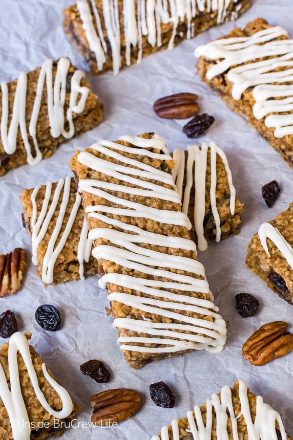 Overhead picture of gingerbread oatmeal bars drizzled with white chocolate on a white background