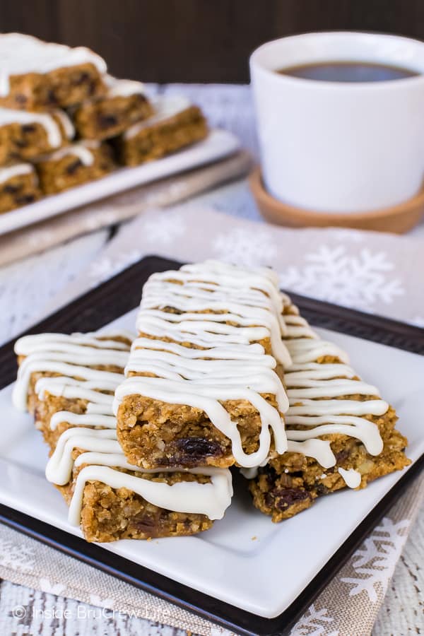 Three Iced Gingerbread Oatmeal Bars stacked on a white plate
