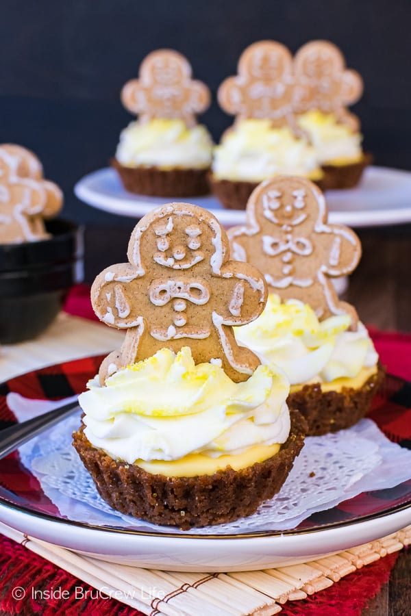 Lemon Gingersnap Cheesecake Tarts on a plate with other tarts in the background.