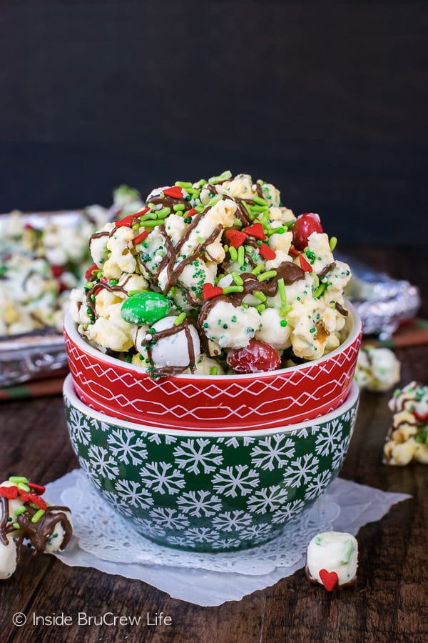 Red and green Christmas bowls filled with Mint Grinch Popcorn. 