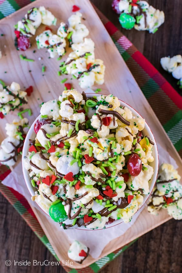 Mint Grinch Popcorn stacked in a bowl on top of a wood platter.