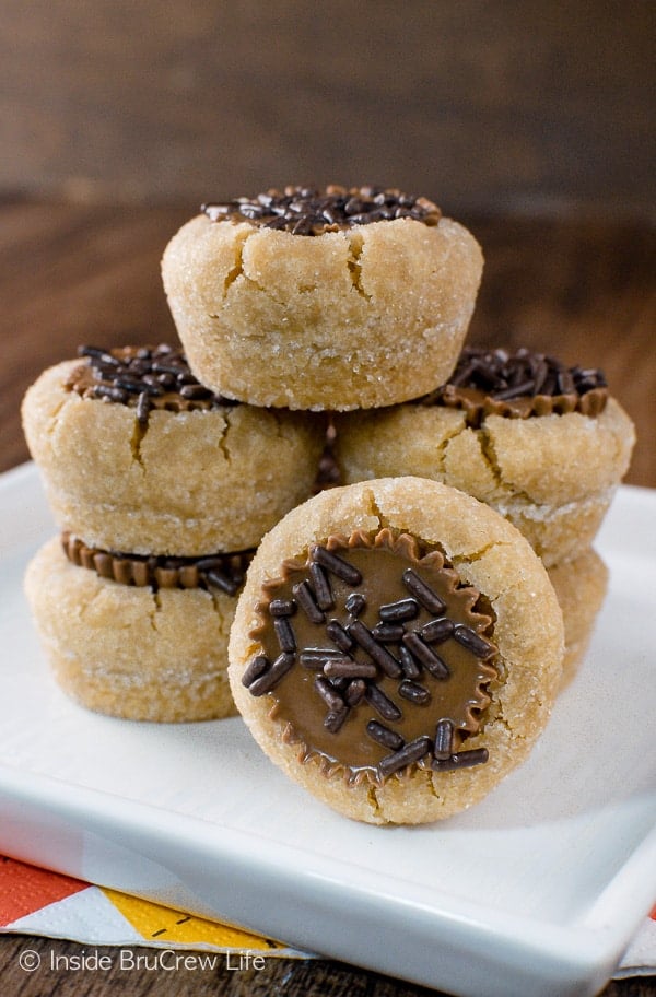 A white plate with peanut butter cup cookies stacked on it.