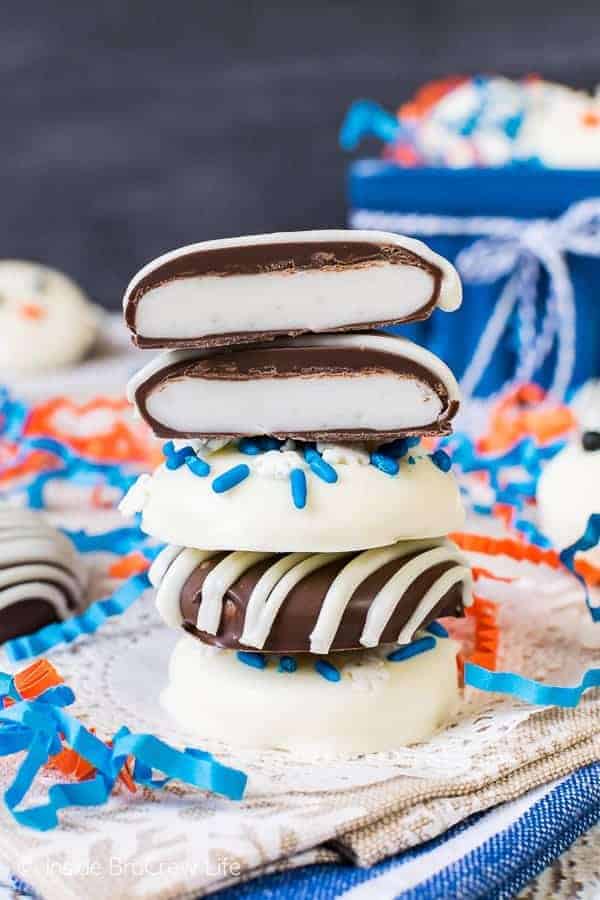 A stack of 4 peppermint patties on a blue and tan towel.