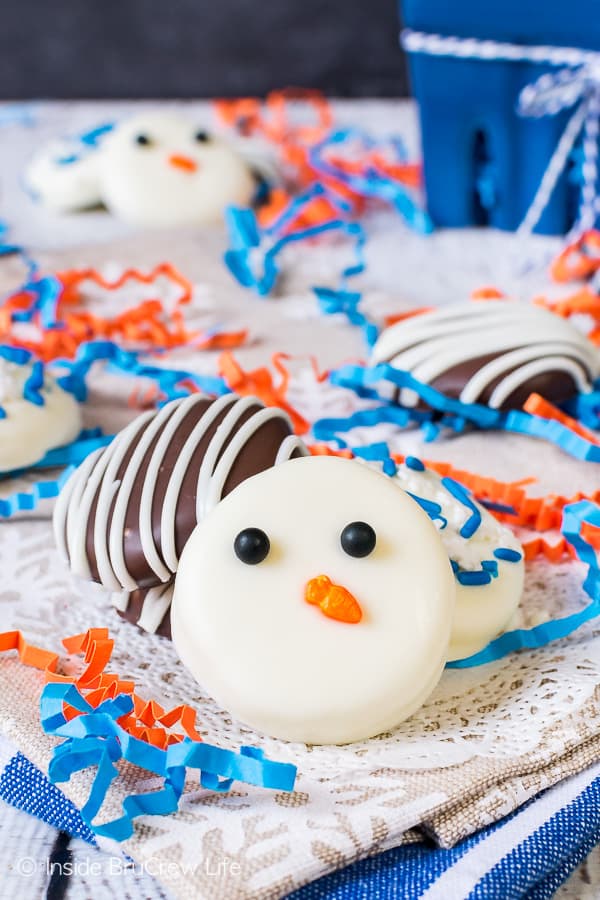 Three peppermint cream patties decorated with sprinkles and chocolate on a white doily.