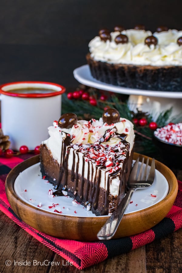 A slice of Peppermint Mocha Fudge Tart drizzled with chocolate and topped with crushed peppermints.