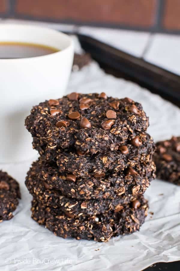 Four banana chocolate chip breakfast cookies stacked on a tray