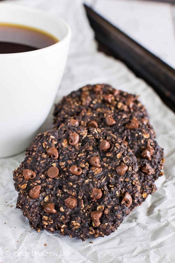 A tray with parchment paper on it and four banana breakfast cookies laying against each other