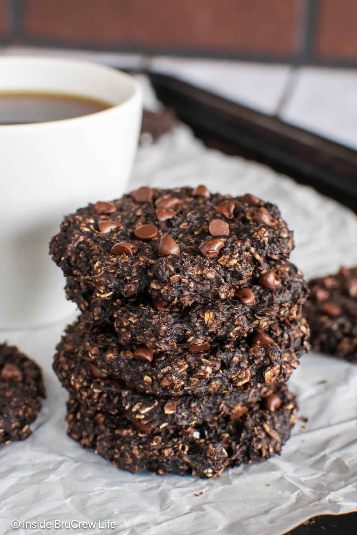 A stack of four chocolate protein oatmeal cookies.