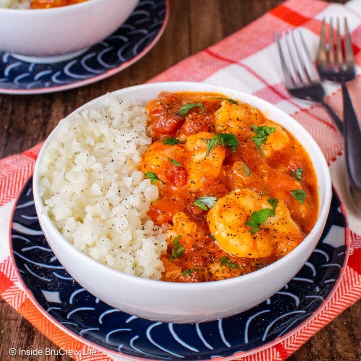 Two white bowls filled with rice and shrimp curry.