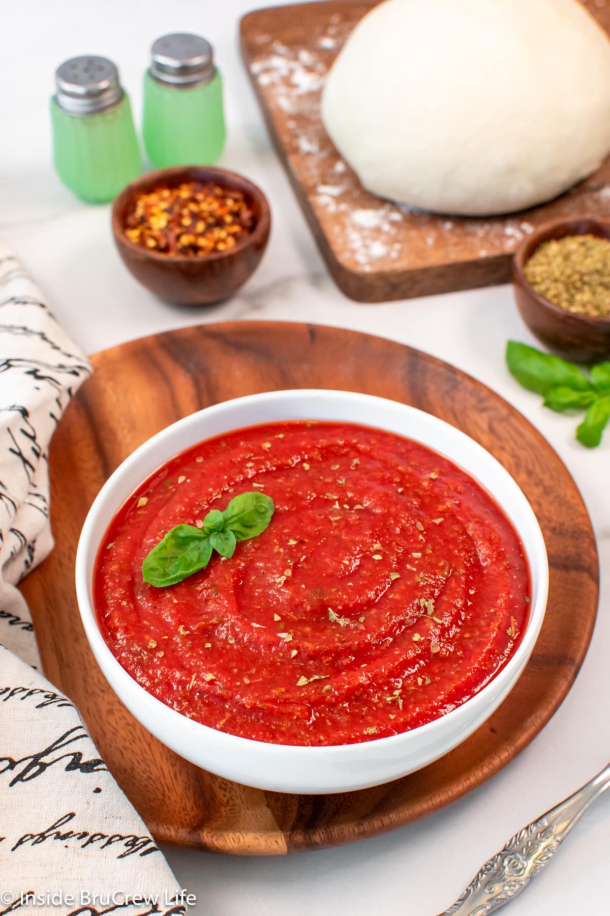 A white bowl filled with a red sauce.