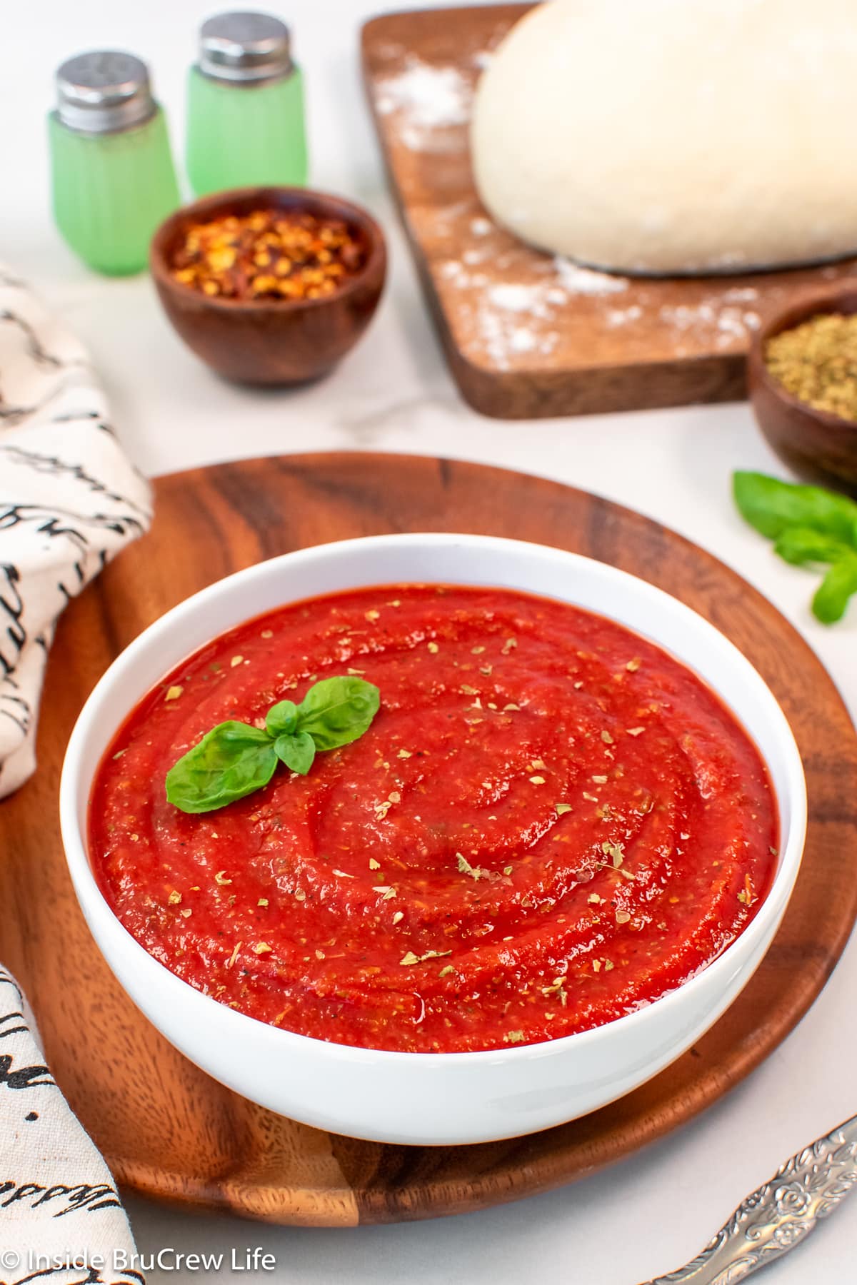 A white bowl filled with a red sauce.