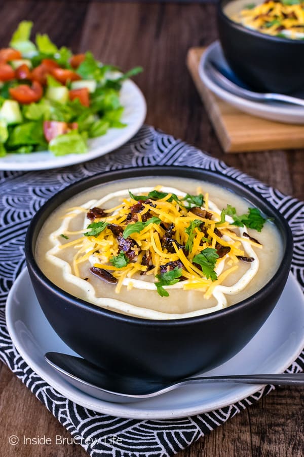 Loaded Cauliflower Soup - this easy soup is loaded with lots of veggies and topped with cheese and bacon. Great comfort food recipe that is healthy!