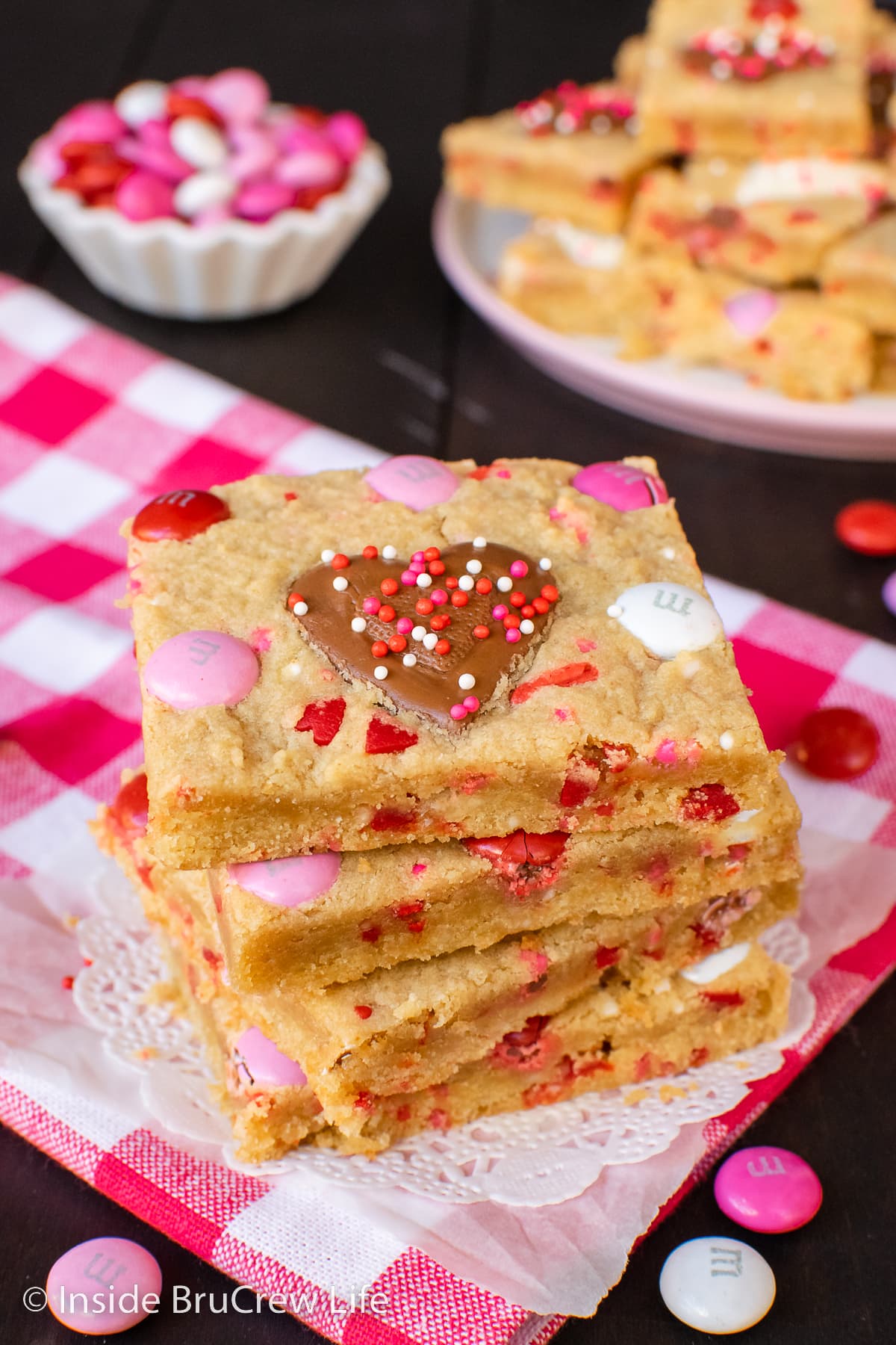 A stack of peanut butter bars with Reese's hearts in them.