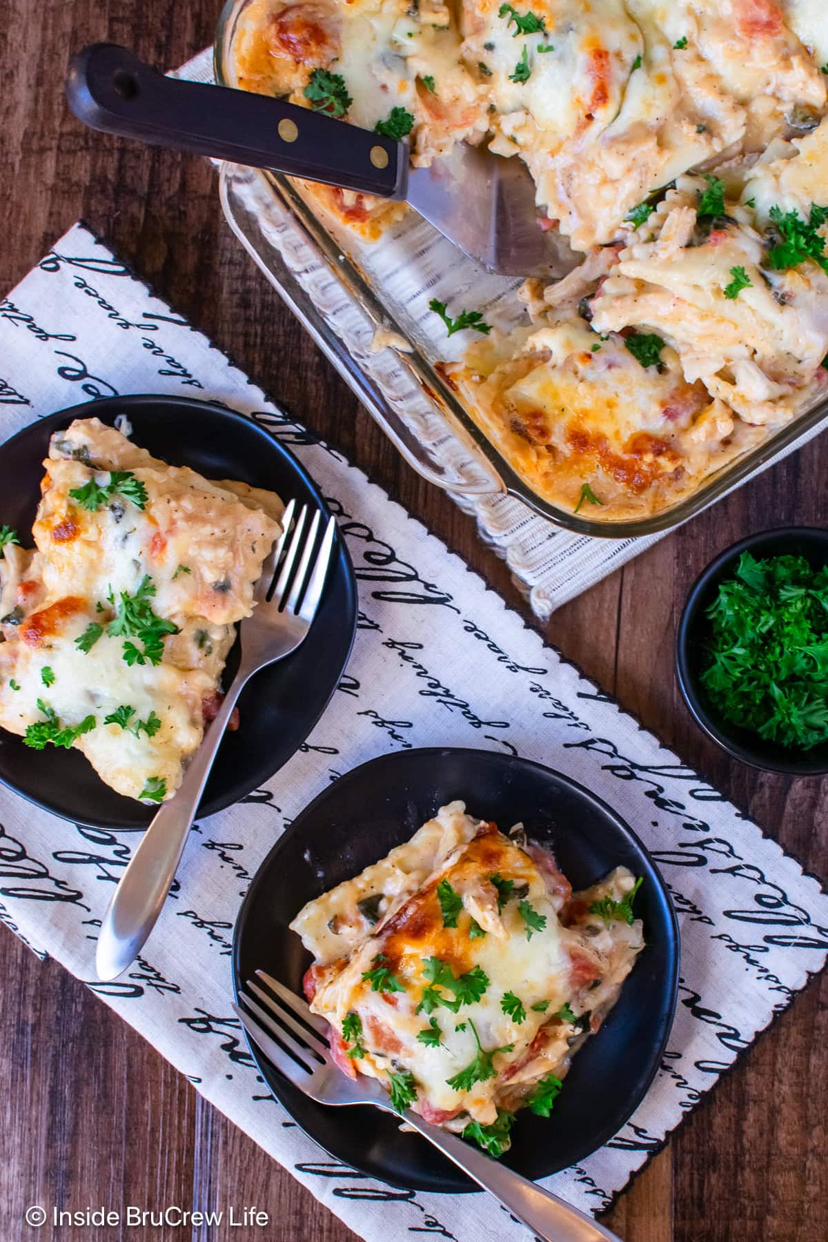 An overhead view of two plates of ravioli bake.