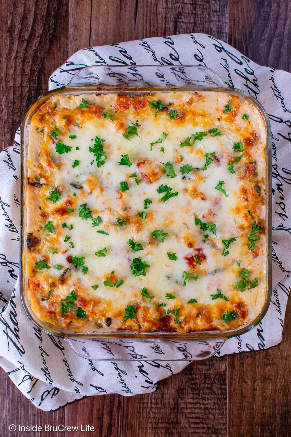 An overhead view of a pan of cheesy baked pasta.