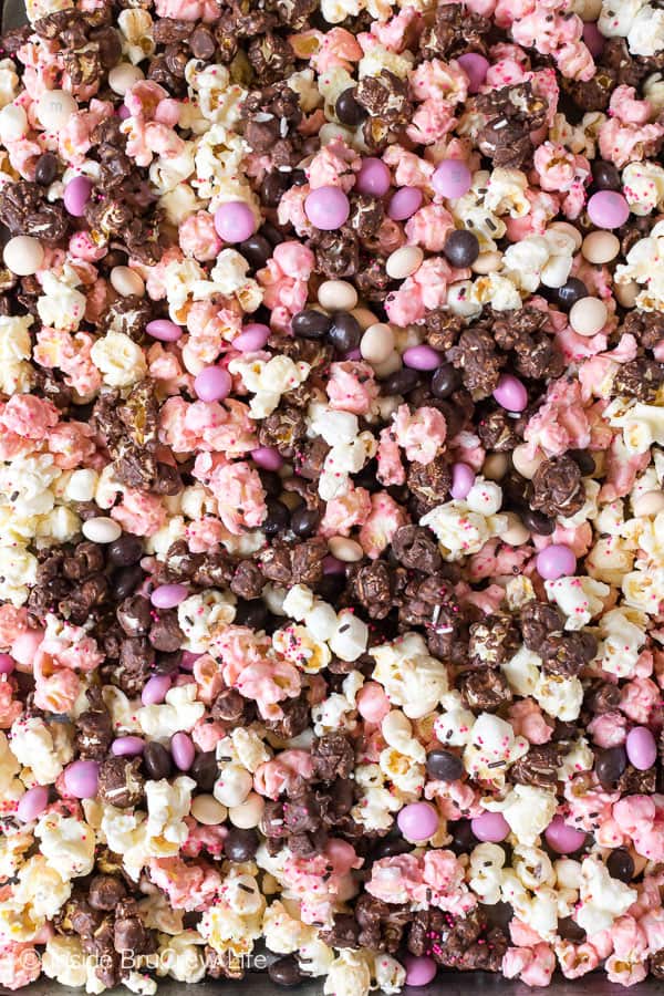 Neapolitan Popcorn - three kinds of chocolate and candies make this easy snack mix a fun treat to make and eat. Great no bake recipe for movie night. #popcorn #chocolate #strawberry #nobake #snackmix #neapolitan 