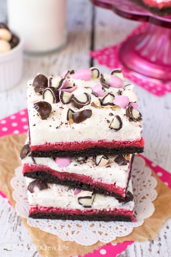 Neapolitan Sugar Cookie Bars - frosting and candies on these layered cookies make these a fun dessert. Great recipe for parties and picnics. #cookies #chocolate #strawberry #vanilla #sugarcookies #easydesserts #barcookies