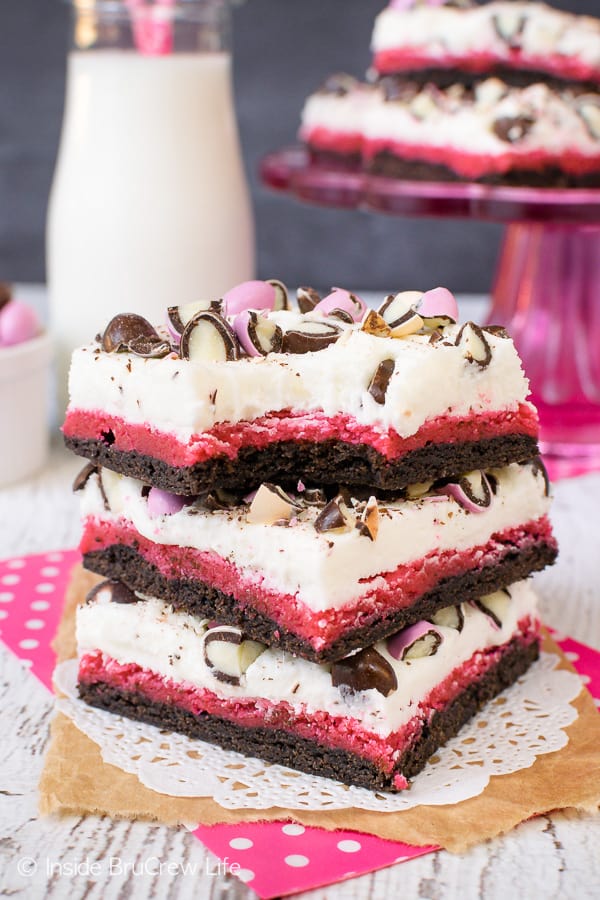 Neapolitan Sugar Cookie Bars - layers of chocolate and strawberry cookie dough topped with vanilla frosting and candies make these bars so fun. Easy recipe to make for parties and picnics. #cookies #chocolate #strawberry #vanilla #sugarcookies #easydesserts #barcookies