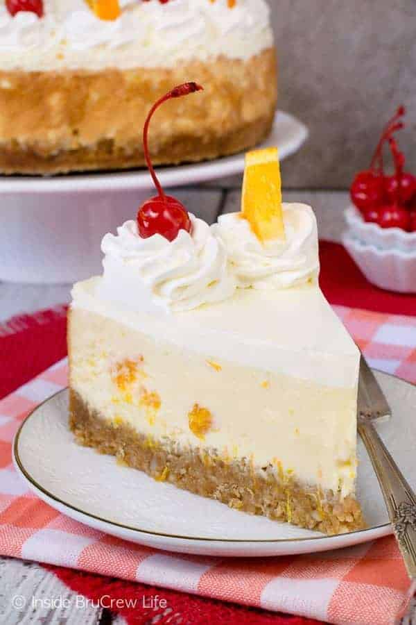 Orange Cream Cheesecake - the crunchy nut crust and creamy orange filled cheesecake makes an impressive dessert. Perfect recipe for any spring or summer picnic or party. #cheesecake #orange #macadamianuts #dessert #recipe #orange #spring #summer 