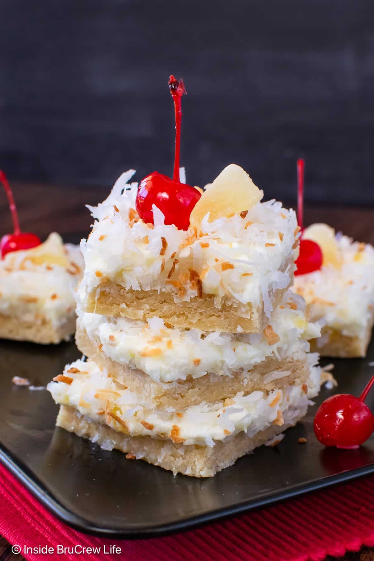 Three frosted pina colada bars stacked on top of each other.