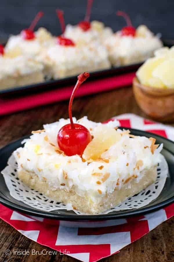 Pina Colada Sugar Cookie Bars - these easy cookie bars are loaded with coconut and pineapple. The creamy frosting and chewy cookies are the perfect tropical treat. Make this easy recipe for dessert or summer picnics. #sugarcookiebars #easy #dessert #frosting #pinacolada #pineapple #coconut #barcookies #bakesale