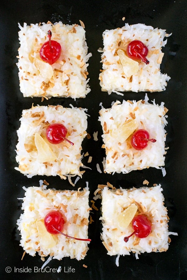 Pina Colada Sugar Cookie Bars - chewy coconut bars with a sweet pineapple frosting makes a delicious tropical dessert. Make this easy recipe for dessert or summer parties. #sugarcookiebars #easy #dessert #frosting #pinacolada #pineapple #coconut #barcookies #bakesale