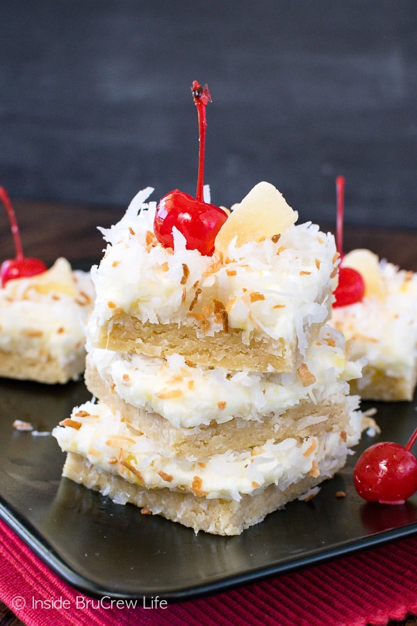 Pina Colada Sugar Cookie Bars - the creamy pineapple frosting makes these chewy coconut cookie bars such a great tropical treat. Make this easy recipe for summer picnics and parties. #sugarcookiebars #easy #dessert #frosting #pinacolada #pineapple #coconut #barcookies #bakesale