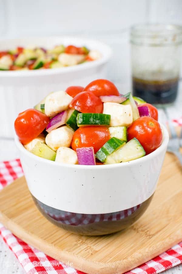 Balsamic Caprese Veggie Salad - this fresh and easy veggie salad is a healthy option to enjoy all summer long. Make this recipe to have with chicken or burgers. #salad #healthy #tomatoes #cucumber #picnic #sidedish #veggies #leanandgreen