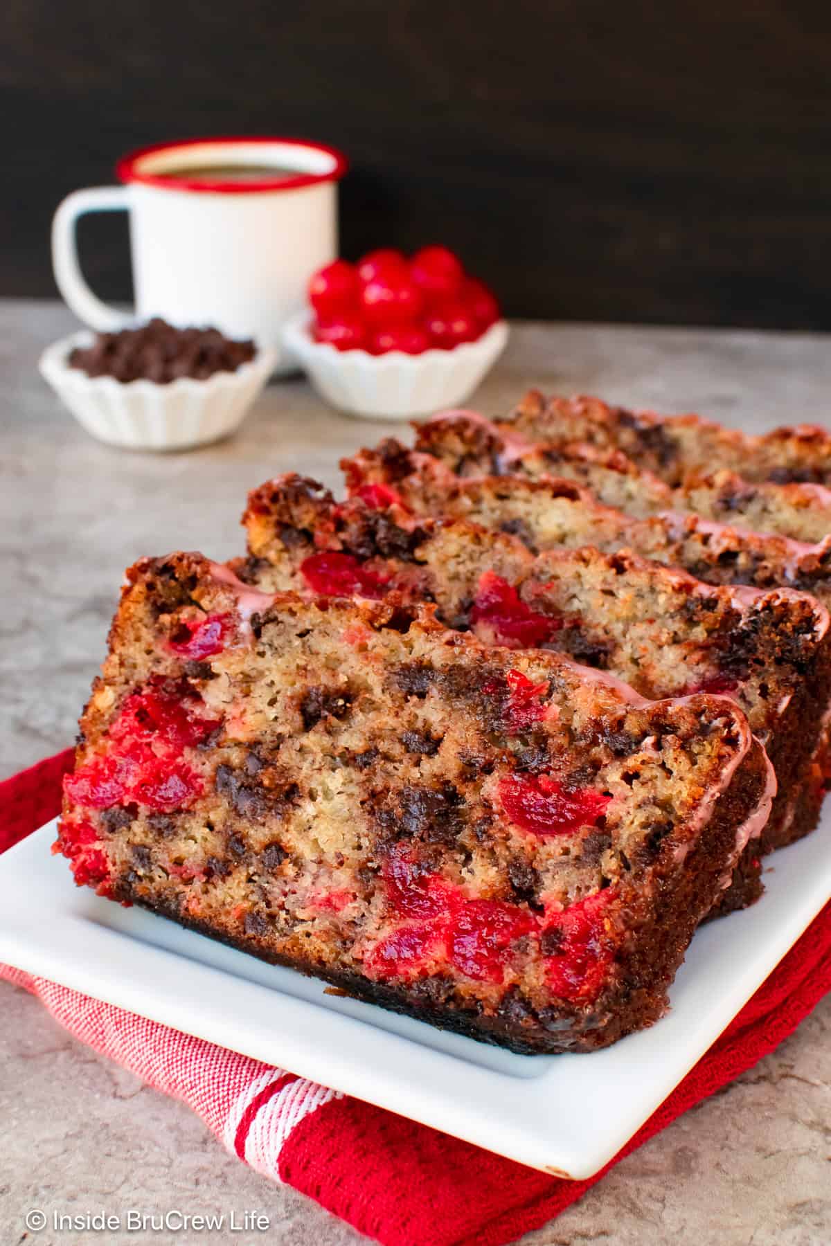 Slices of cherry banana bread on a white plate.