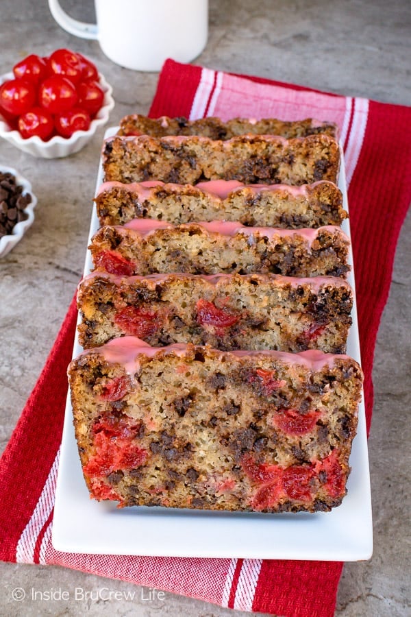 Slices of cherry banana bread with chocolate chips on a white plate.