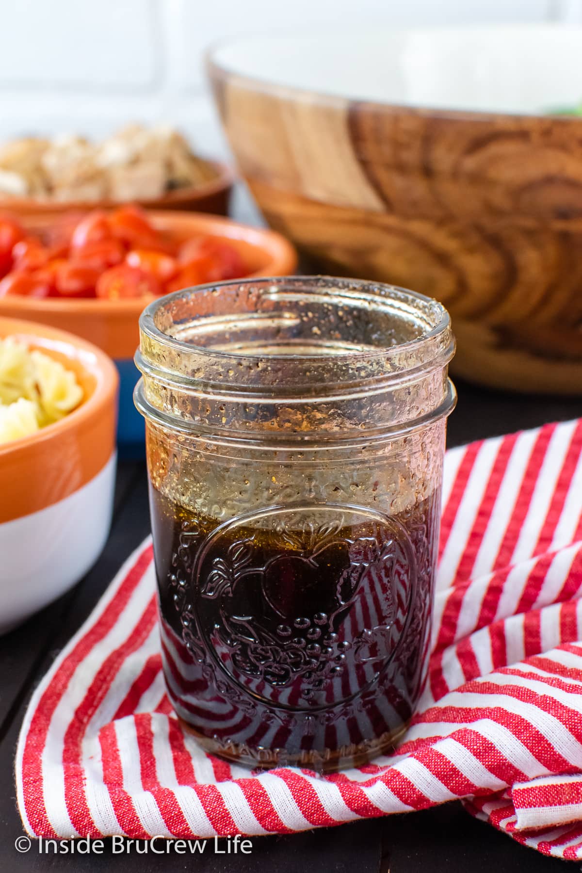 A clear jar filled with balsamic dressing.