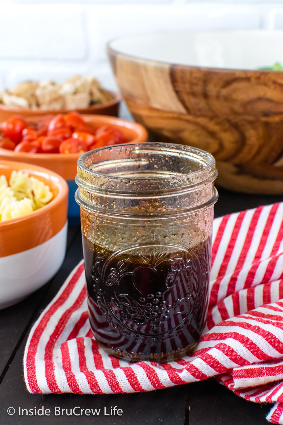 A clear jar filled with salad dressing.