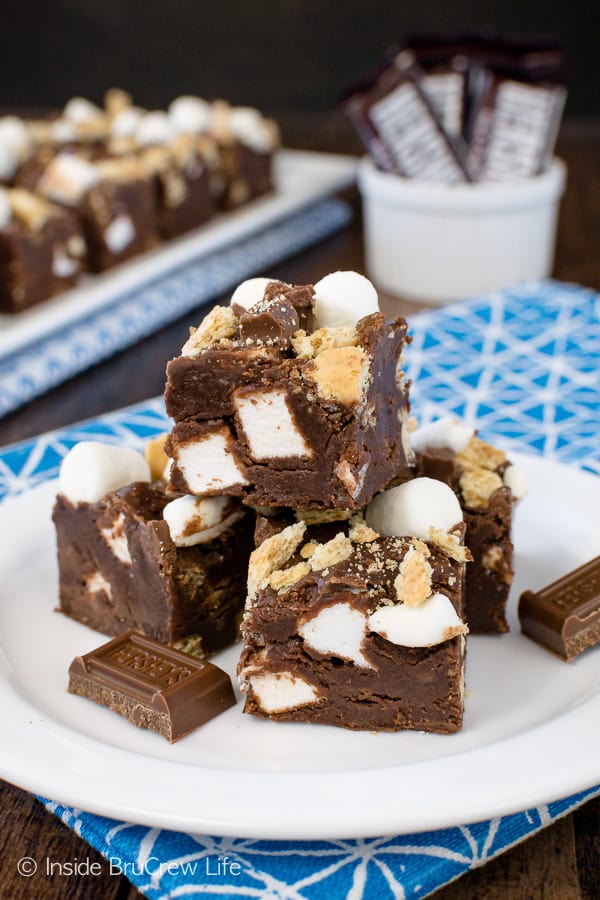 A white plate with squares of marshmallow chocolate fudge on it.