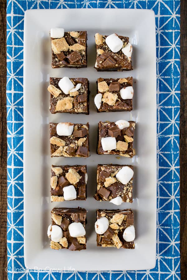 A long white plate with squares of chocolate fudge on it.