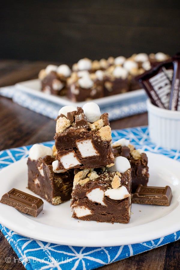 Squares of chocolate fudge on a white plate.