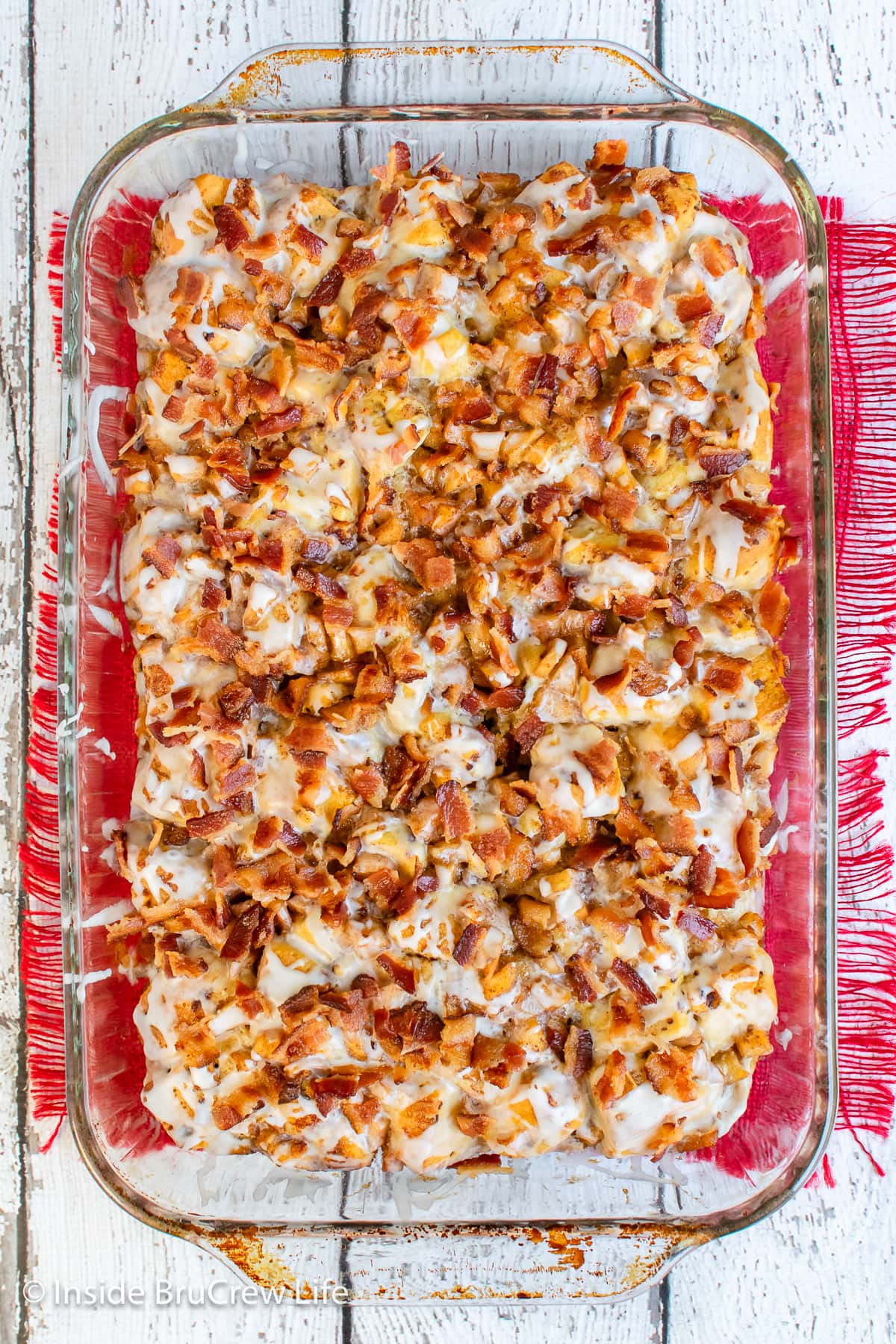 A breakfast casserole in a clear dish.