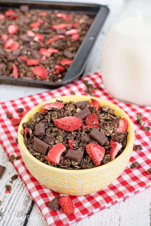 Chocolate Covered Strawberry Granola - this easy homemade granola is loaded with chocolate chunks and freeze dried strawberries. It's the perfect recipe to make for breakfast or afternoon snacks! #granola #homemade #chocolate #breakfast #snackmix #strawberry #afterschoolsnack #healthy #healthysnack