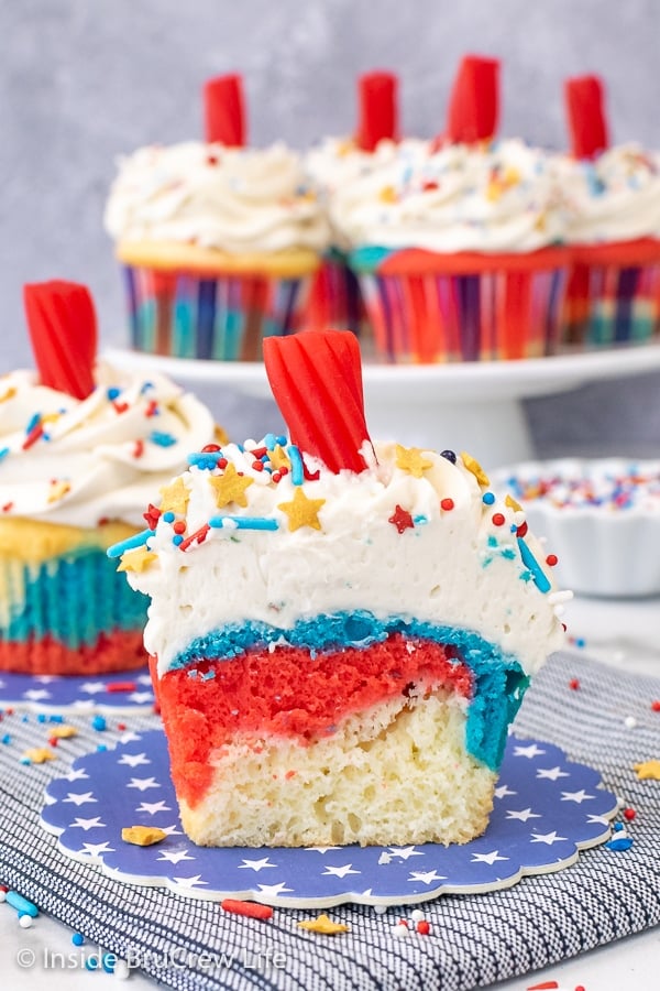 A red white and blue cupcake cut in half showing the swirls of colors inside.