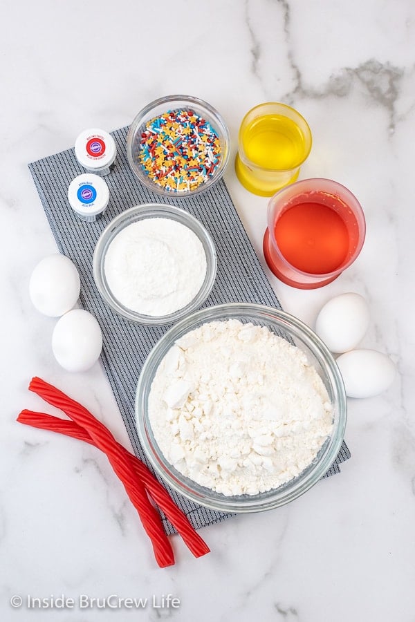 A white board with the ingredients needed to make Firecracker Cupcakes.