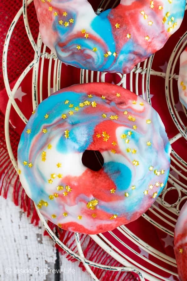 Patriotic Glazed Funfetti Donuts - these easy baked donuts have a fun swirl of red, white, and blue on top and sprinkles inside. Make this recipe for Fourth of July mornings! #donuts #homemade #funfetti #redwhiteandblue #galaxydonuts #patriotic #4thofJuly #summer