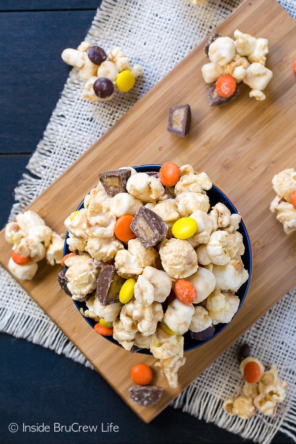 Salted Caramel Reese's Popcorn - this sweet and salty no bake snack mix is loaded with Reese's candies and sea salt. Try this easy recipe for your next movie night! #popcorn #saltedcaramel #peanutbuttercups #reesespieces #snackmix #nobake #sweetandsalty