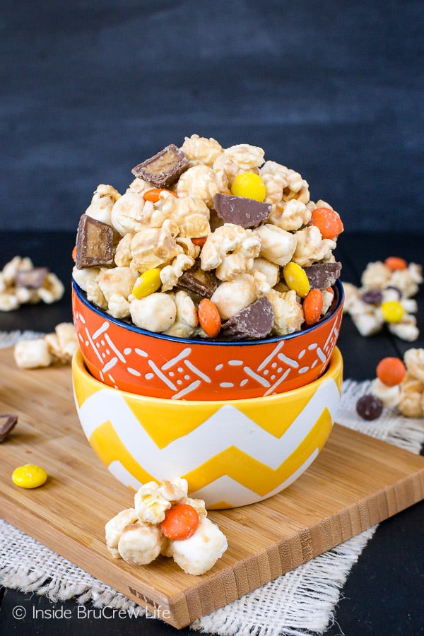 Salted Caramel Reese's Popcorn - this easy no bake snack mix has two kinds of Reese's candies, marshmallows, and sea salt. Try this sweet and salty recipe for your next movie night. #popcorn #saltedcaramel #peanutbuttercups #reesespieces #snackmix #nobake #sweetandsalty