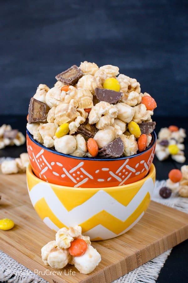 Salted Caramel Reese's Popcorn - this easy snack mix is loaded with salted caramel and two kinds of Reese's candies. Make this recipe to munch on during movie nights! #popcorn #saltedcaramel #peanutbuttercups #reesespieces #snackmix #nobake #sweetandsalty