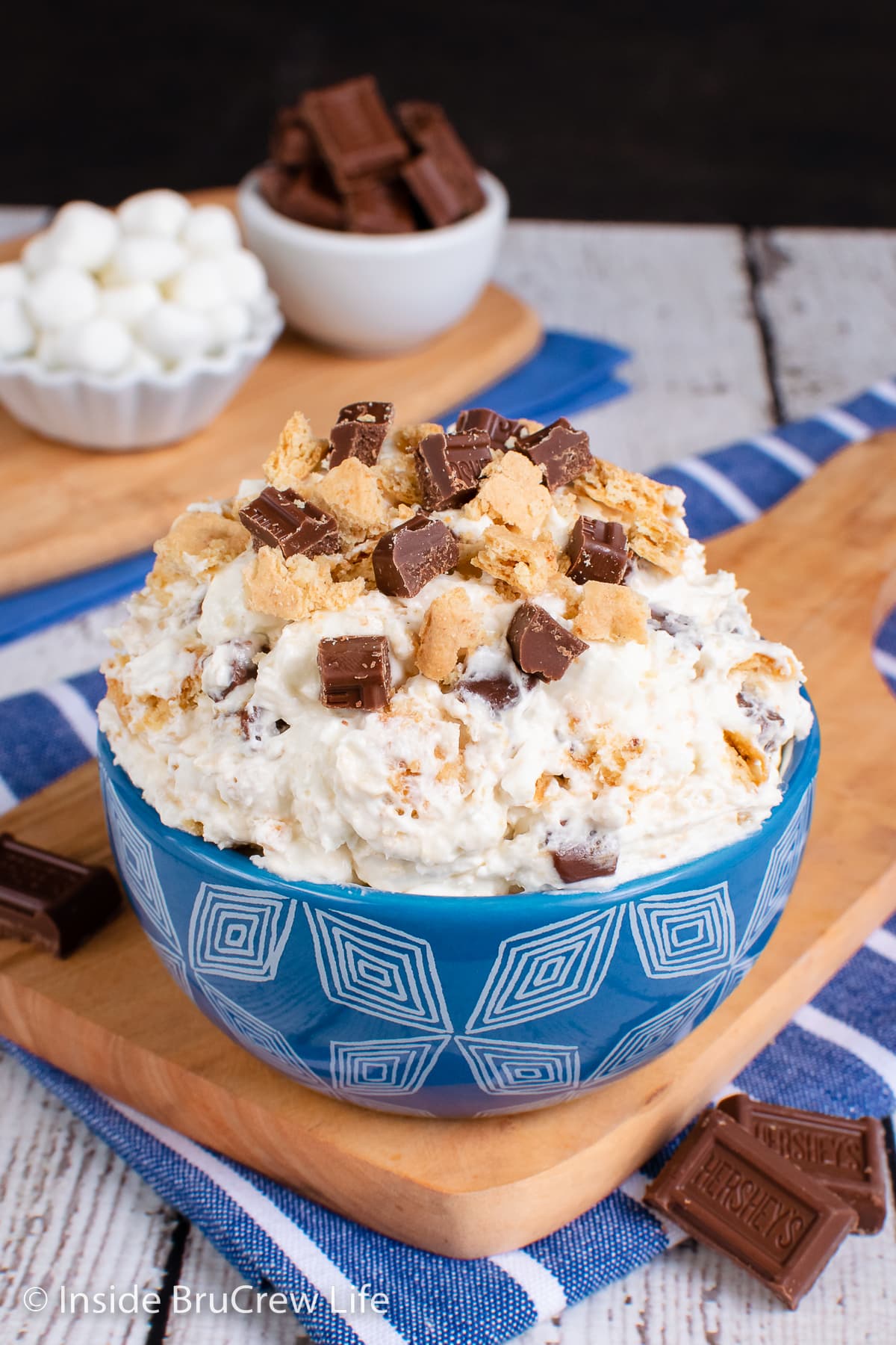 A blue bowl filled with a fluffy marshmallow salad.