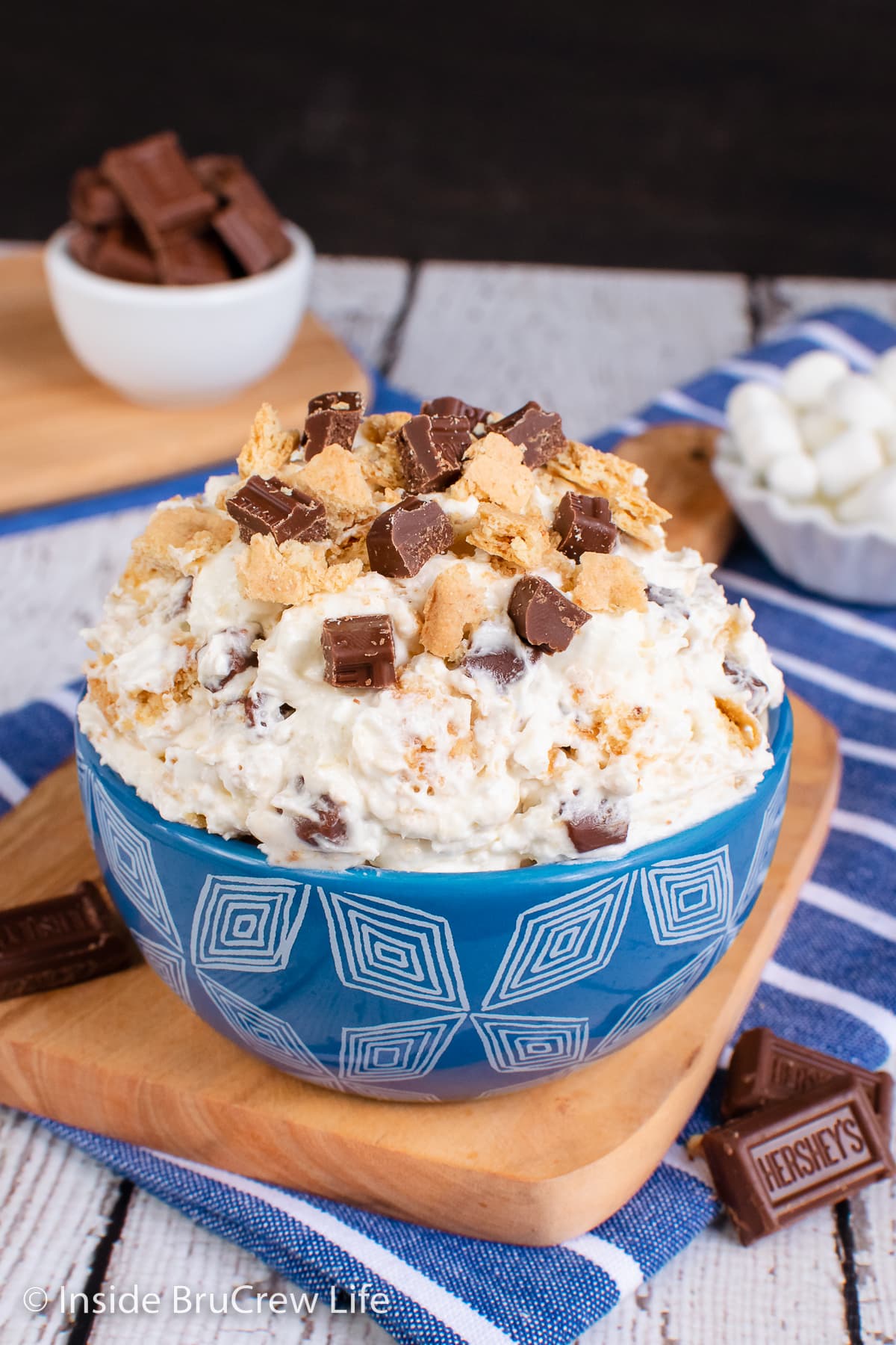 A blue bowl filled with a fluffy dessert salad.