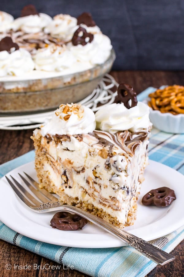 A white plate with a slice of chubby hubby ice cream pie and a fork with more pie behind it.