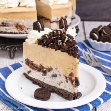 A slice of coffee ice cream cake with an Oreo crust and a layer of cookies and cream ice cream.