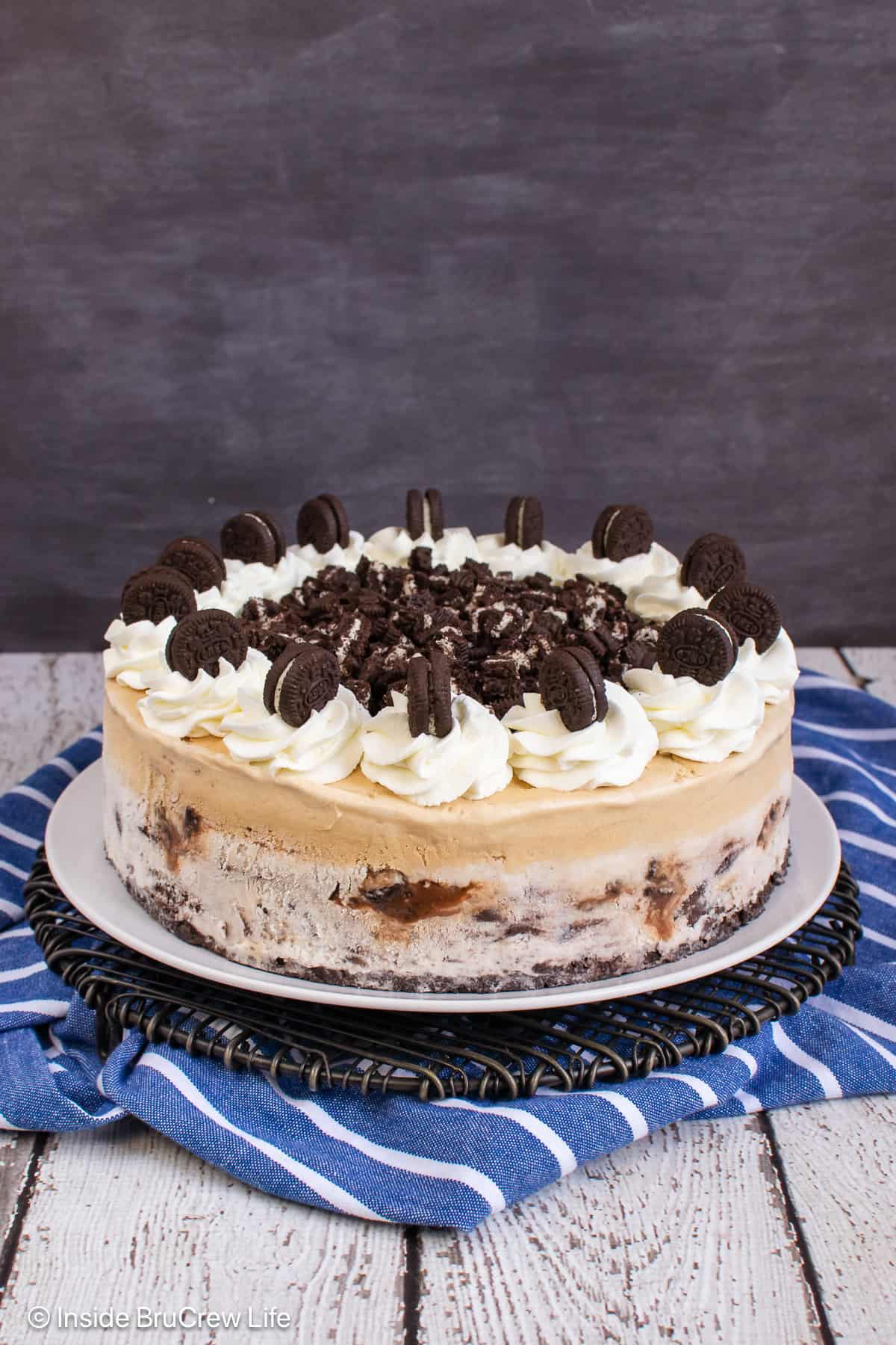 A decorated coffee ice cream cake on a serving plate.