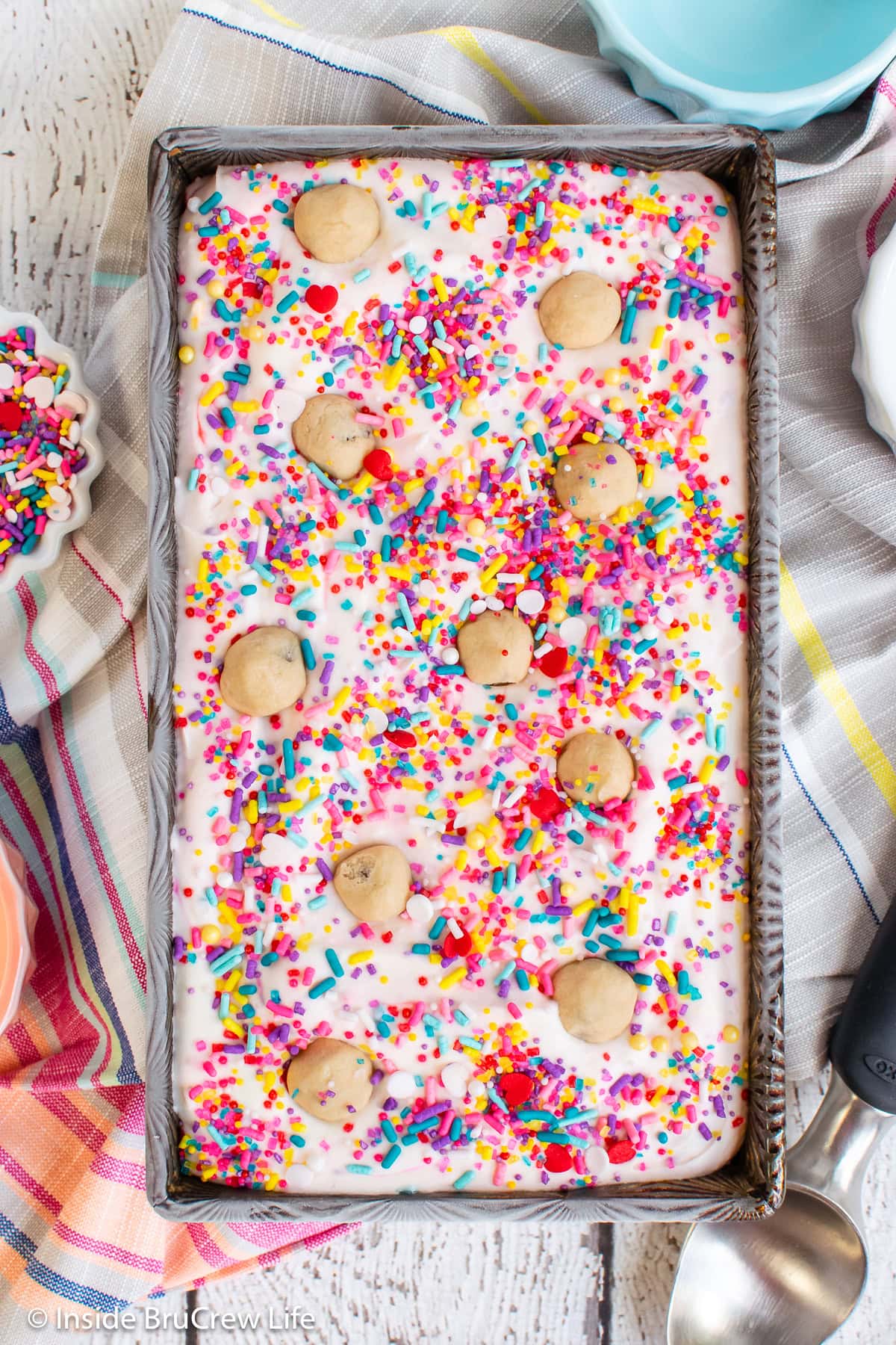 A pan of no churn ice cream filled with sprinkles and cookie dough bites.